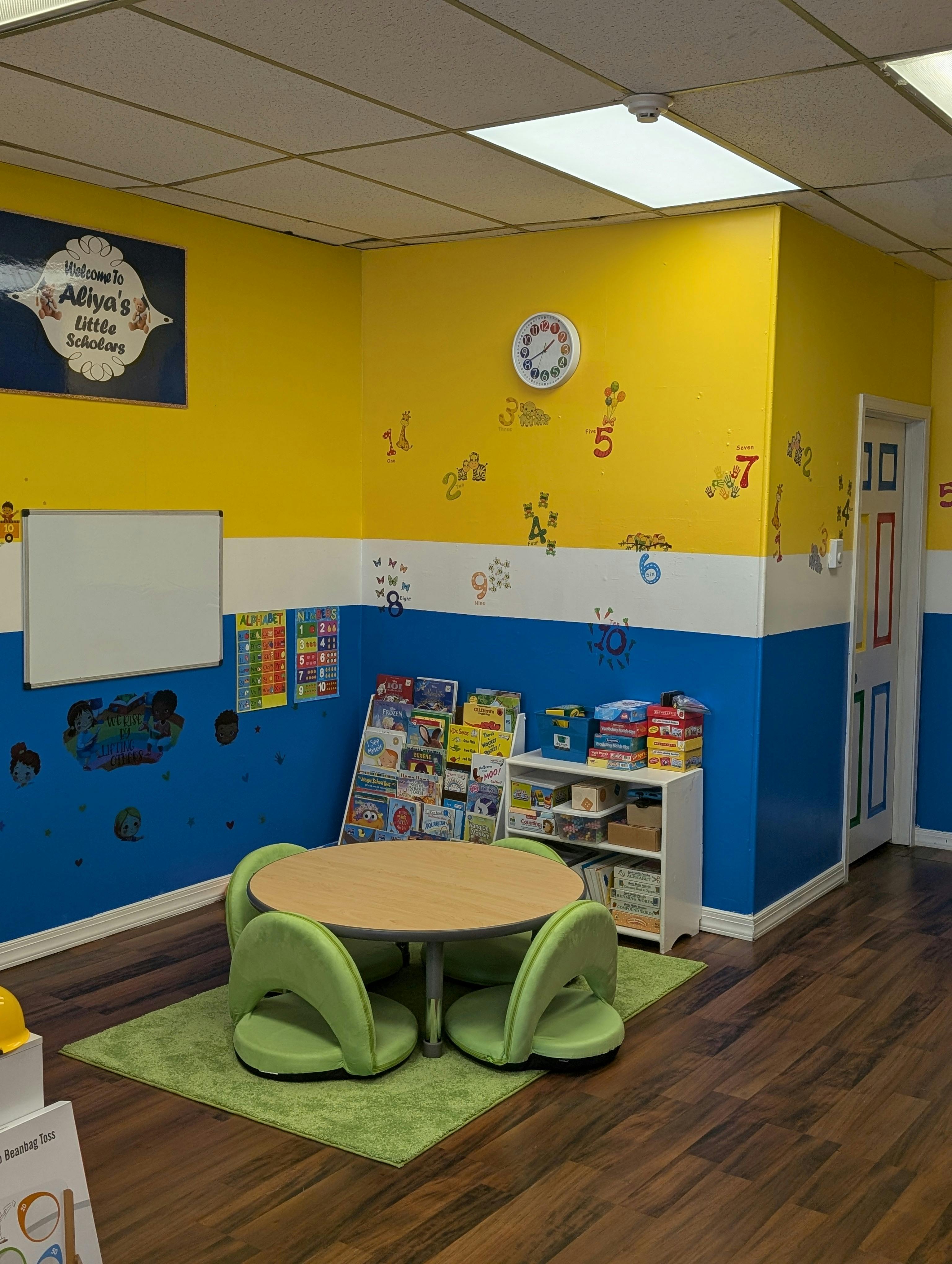 Children's classroom with small table and chairs, colorful walls