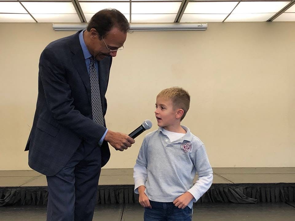 Person holding a microphone to a child