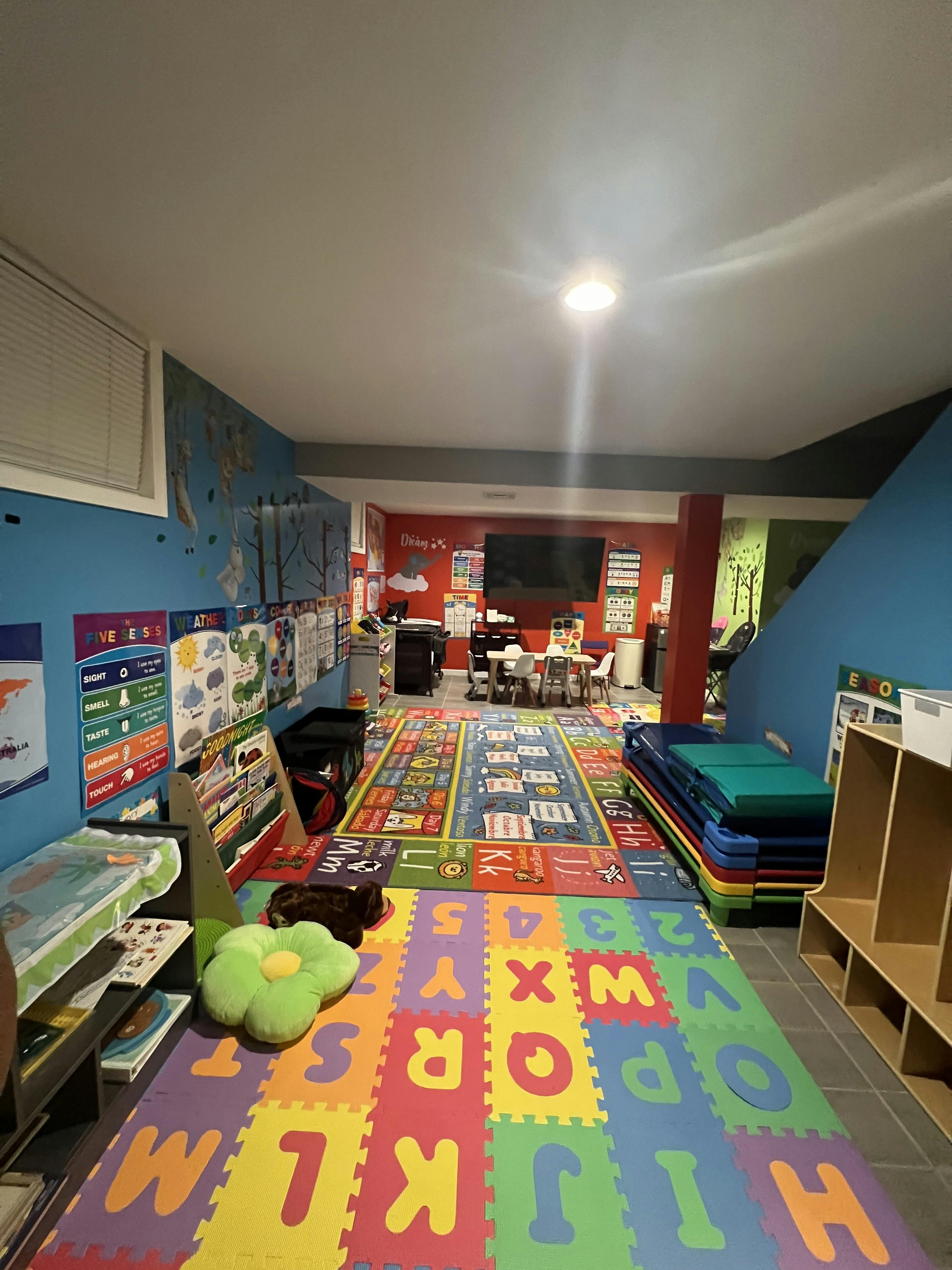 Colorful playroom with alphabet floor mats and educational wall posters