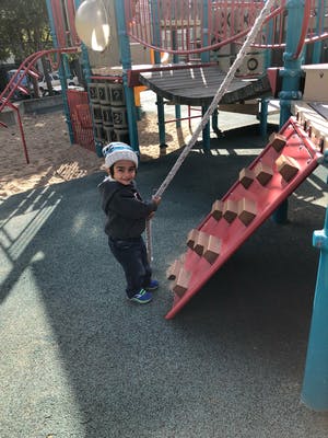 Child holding a rope on a playground
