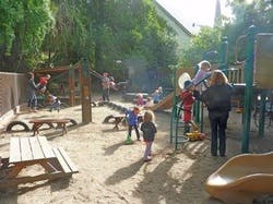 People and children playing on a playground