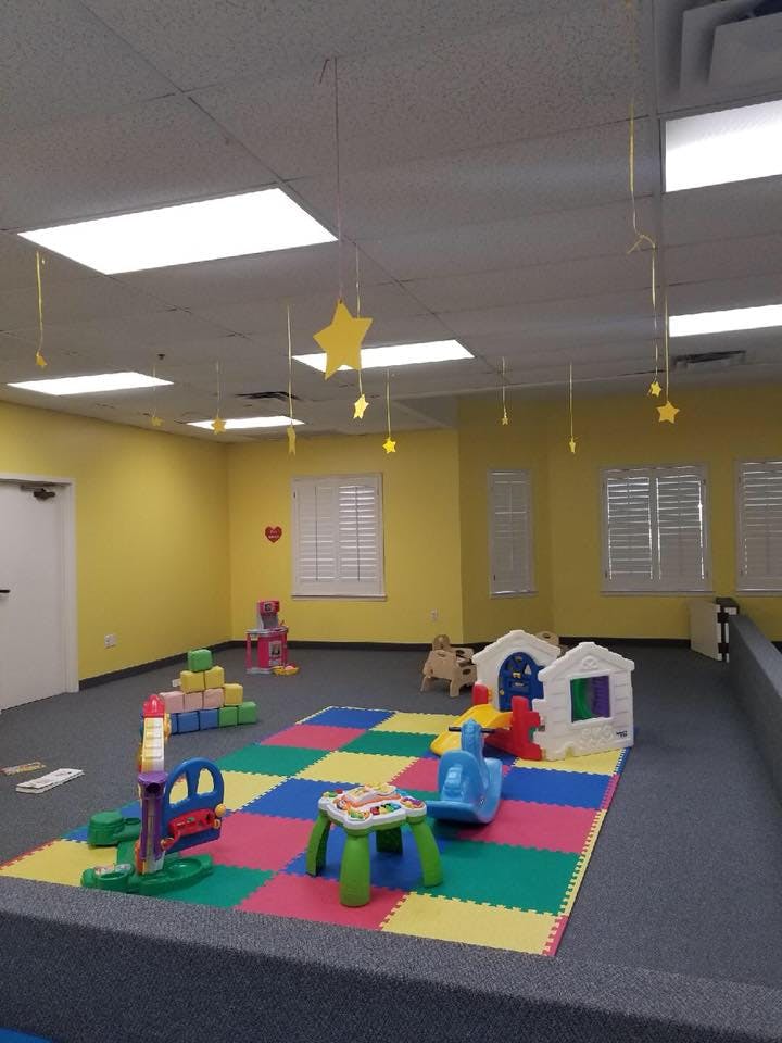 Playroom with colorful floor mats and various toys