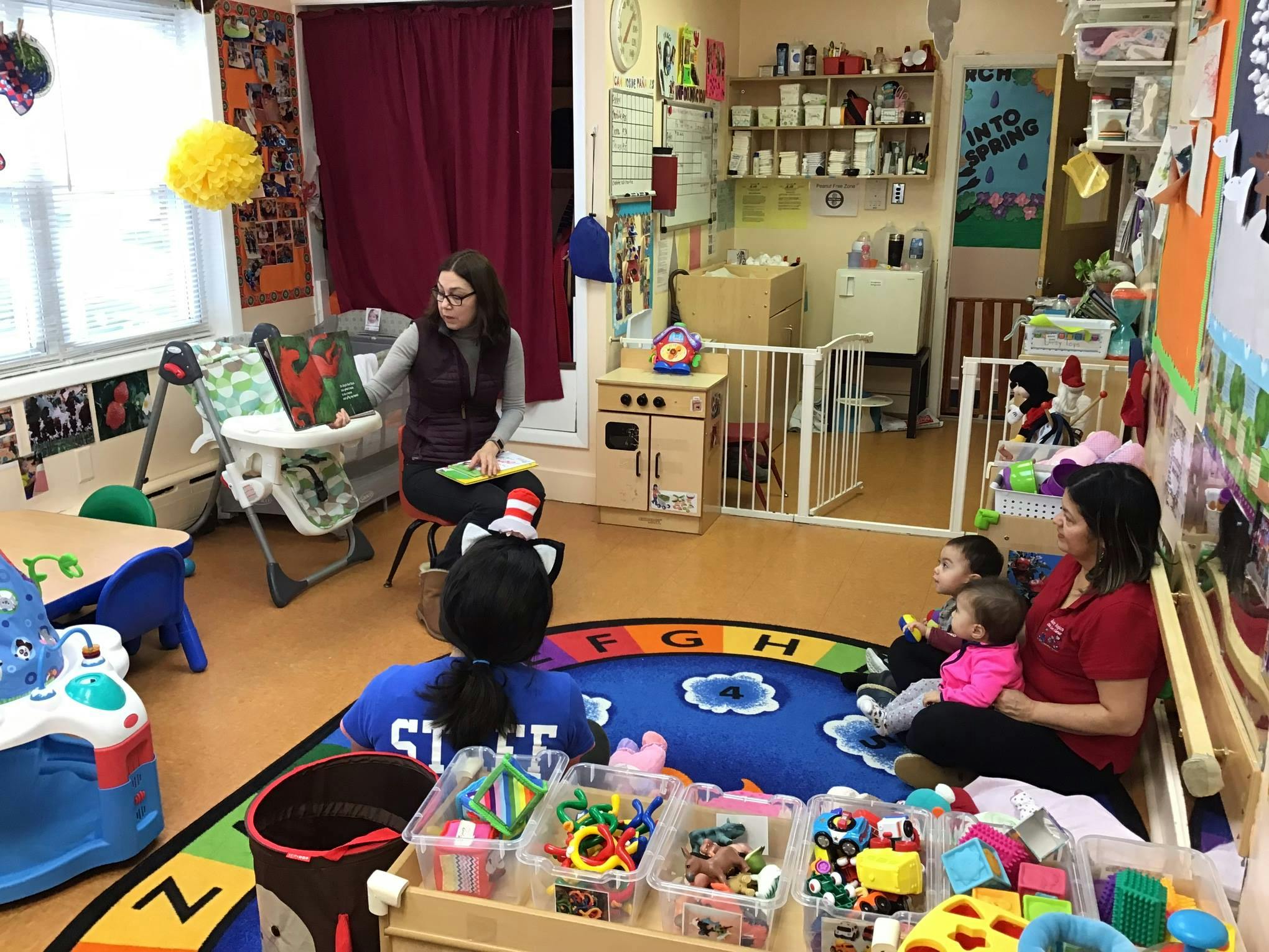 Two adults with children in a classroom