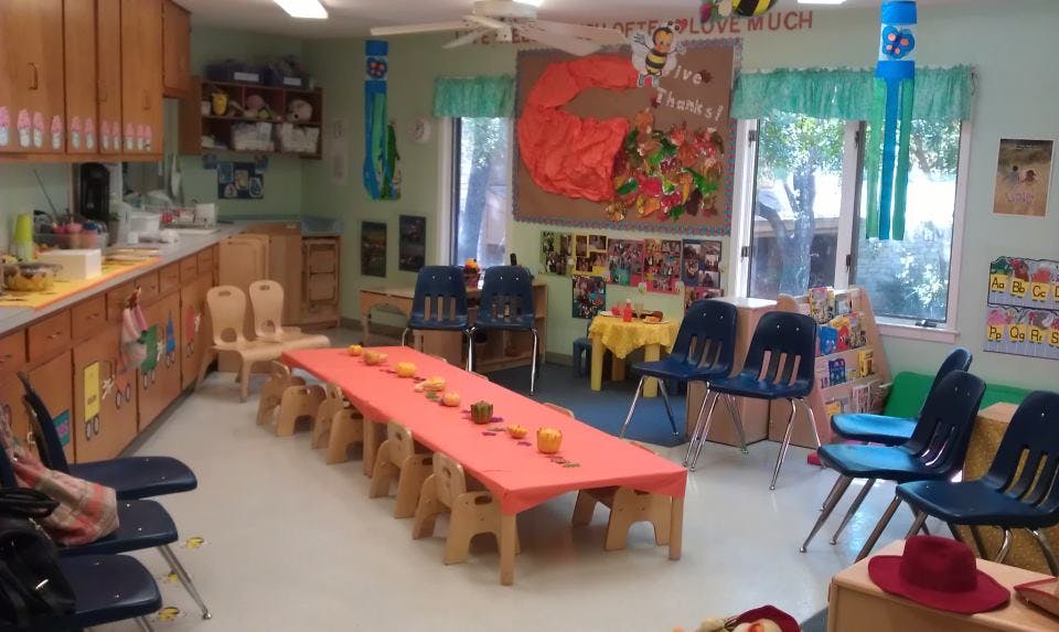 Classroom with a long table and chairs, decorated walls