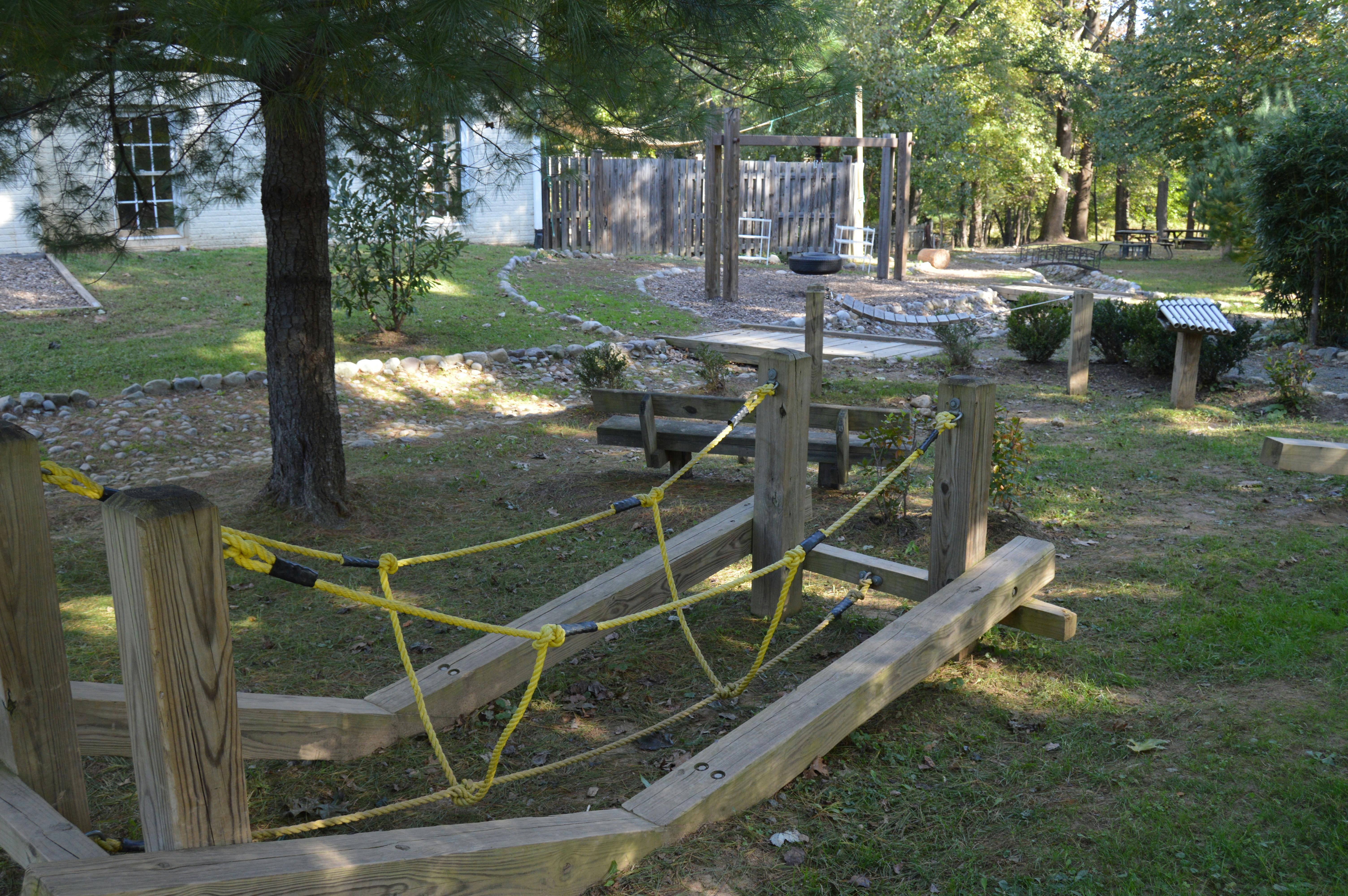 Wooden playground structure with yellow rope netting