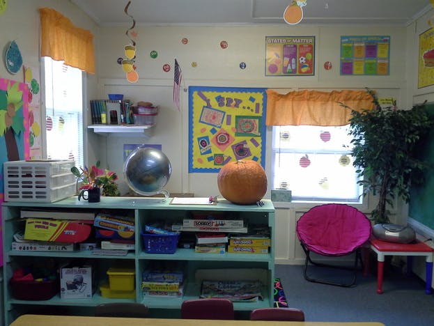 Classroom with a pumpkin and globe on a bookshelf