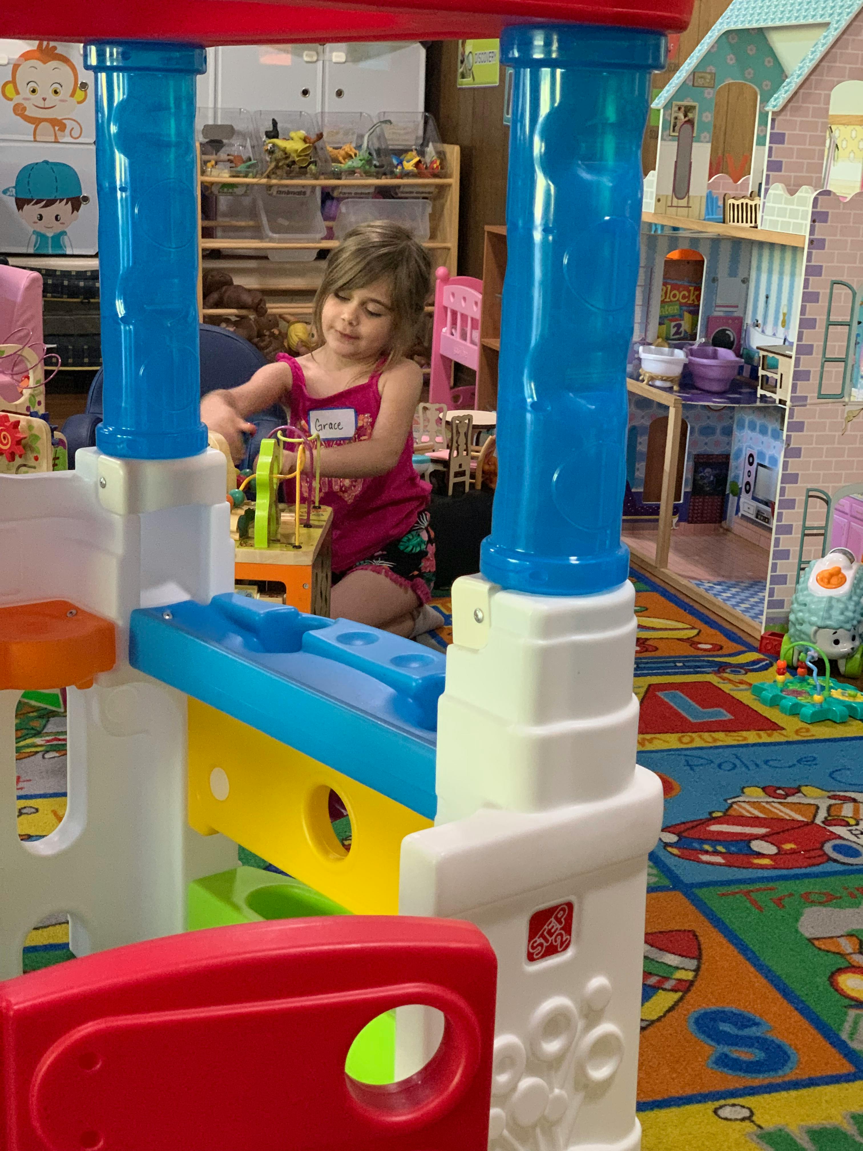 Child playing with toys in a classroom