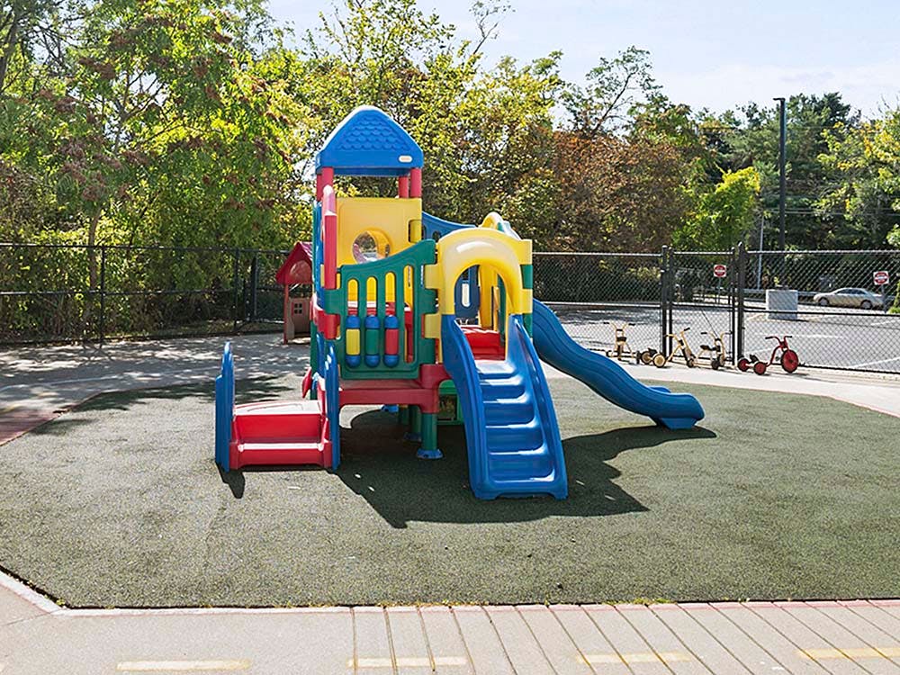Colorful plastic playground structure with slides and climbing areas