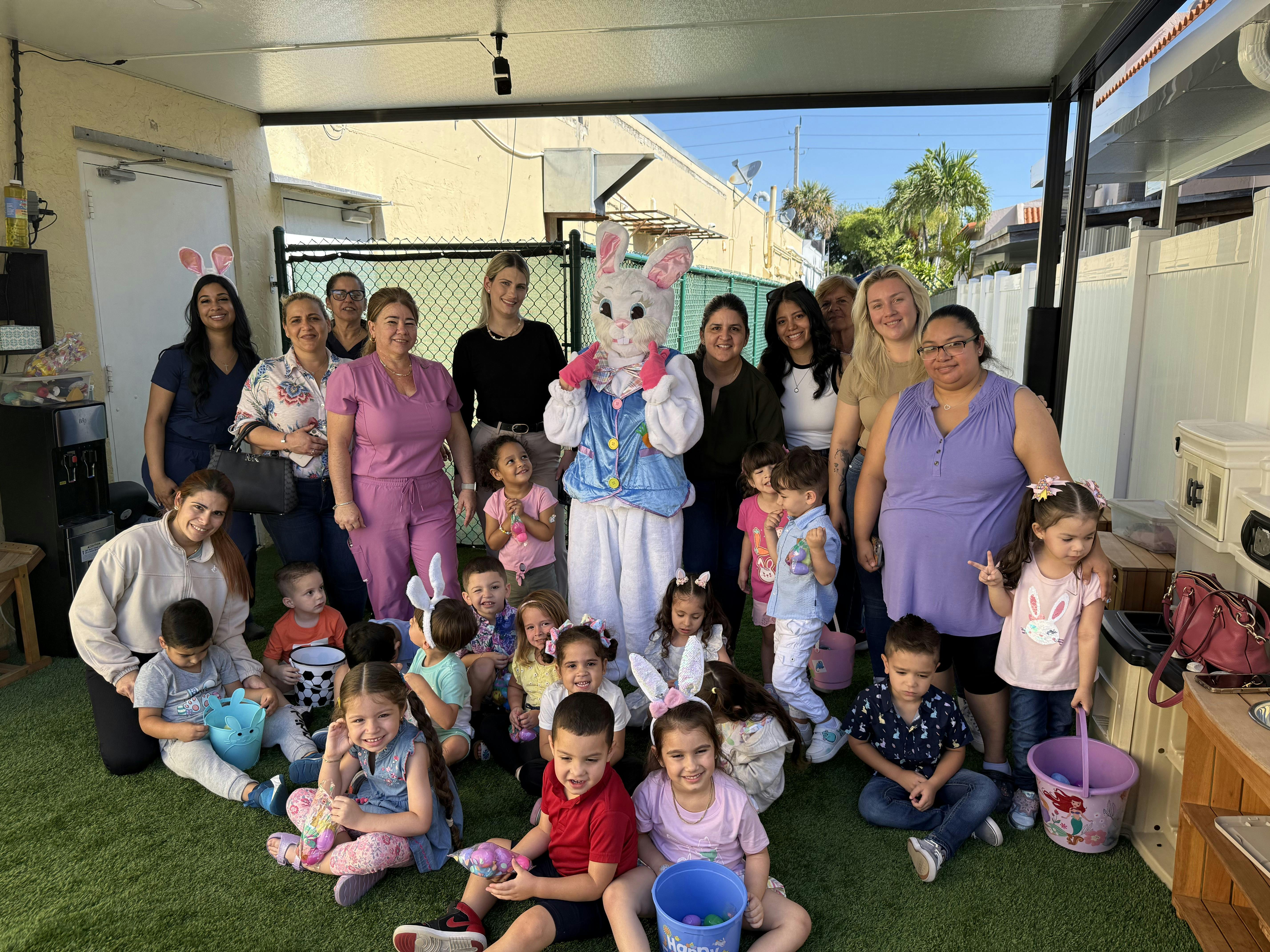 Adults and children with a person in a bunny costume