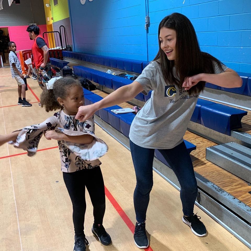 Teen and child playing together indoors