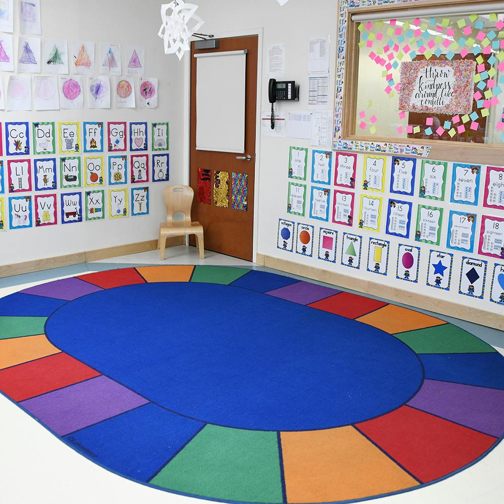 Classroom with a colorful rug and student artwork on the walls