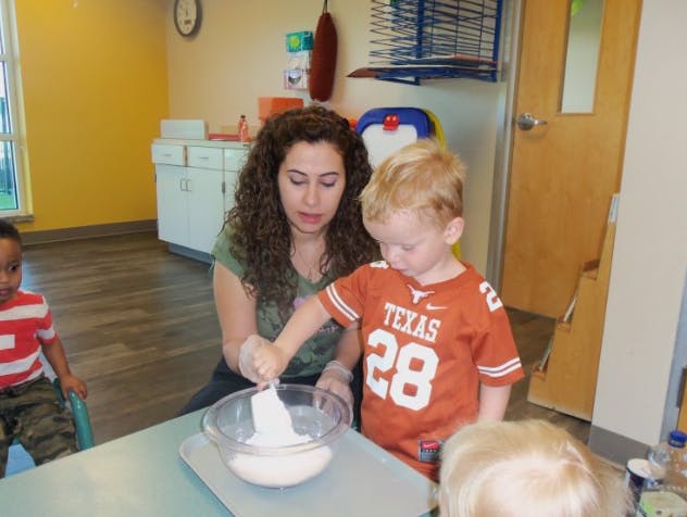 Adult and child mixing ingredients in a bowl