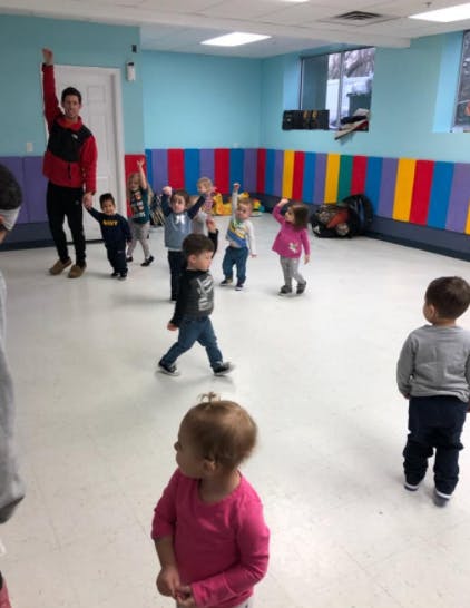 Adult and children in a room with colorful padded walls