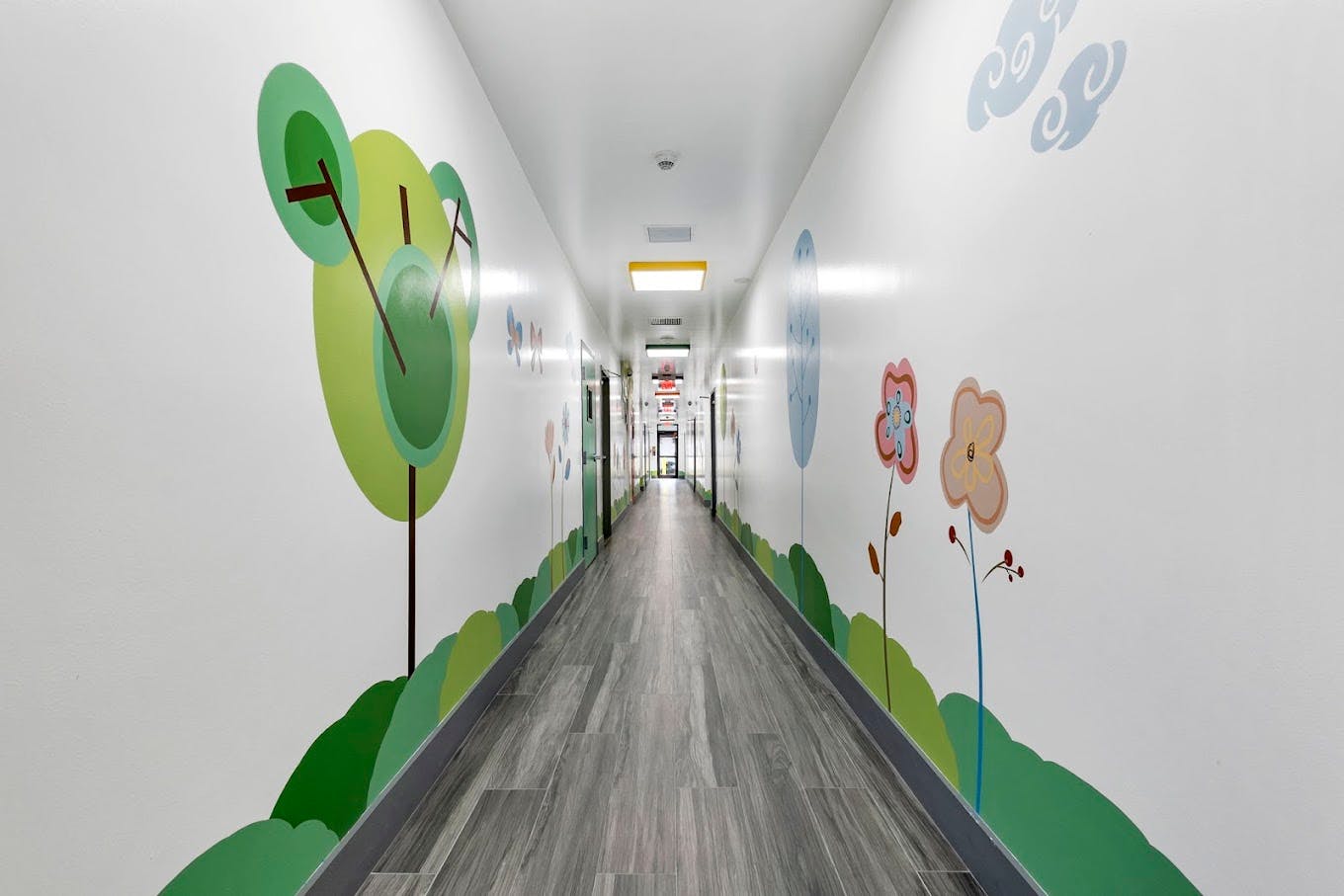 Long hallway with cartoon-like wall decorations