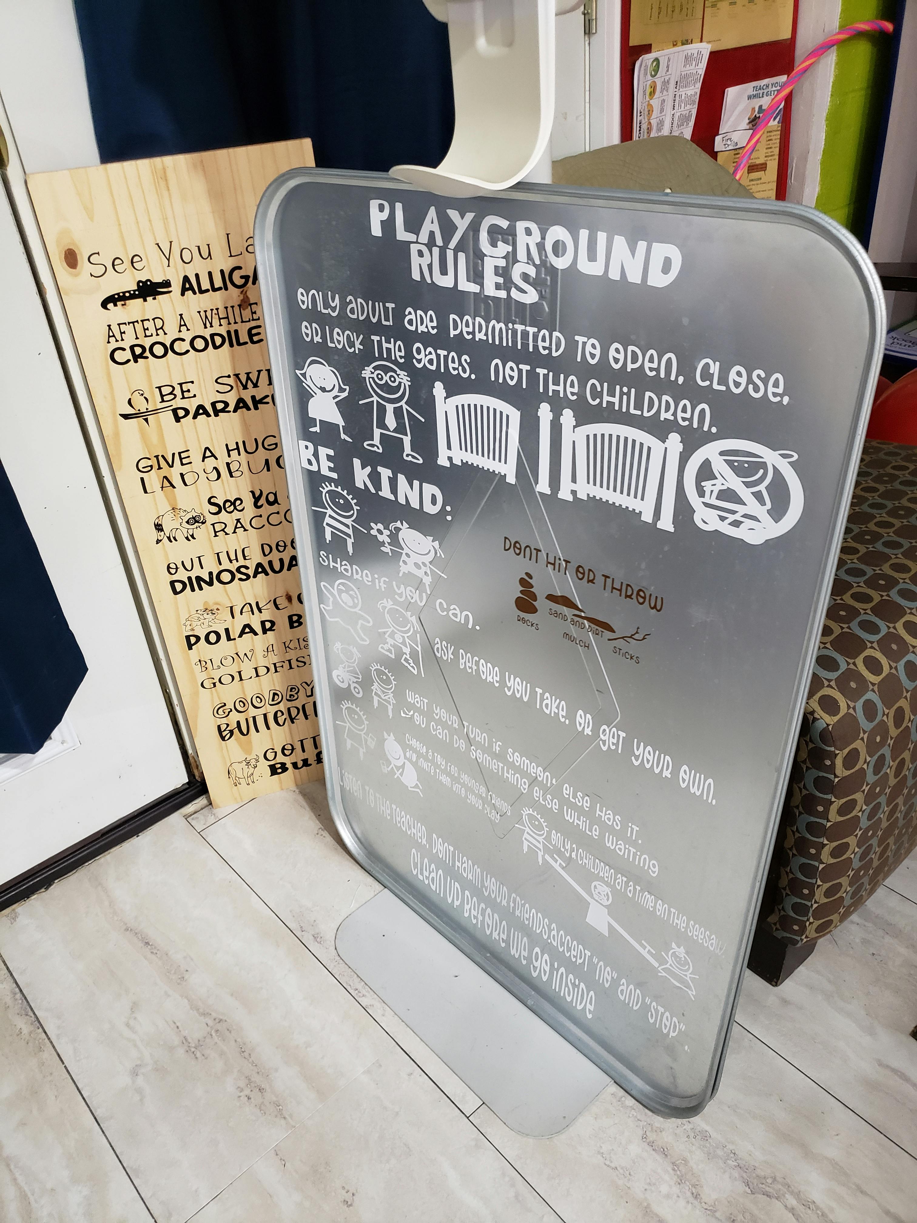 Playground rules sign with text and illustrations