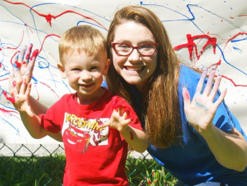 Person and child with paint on their hands