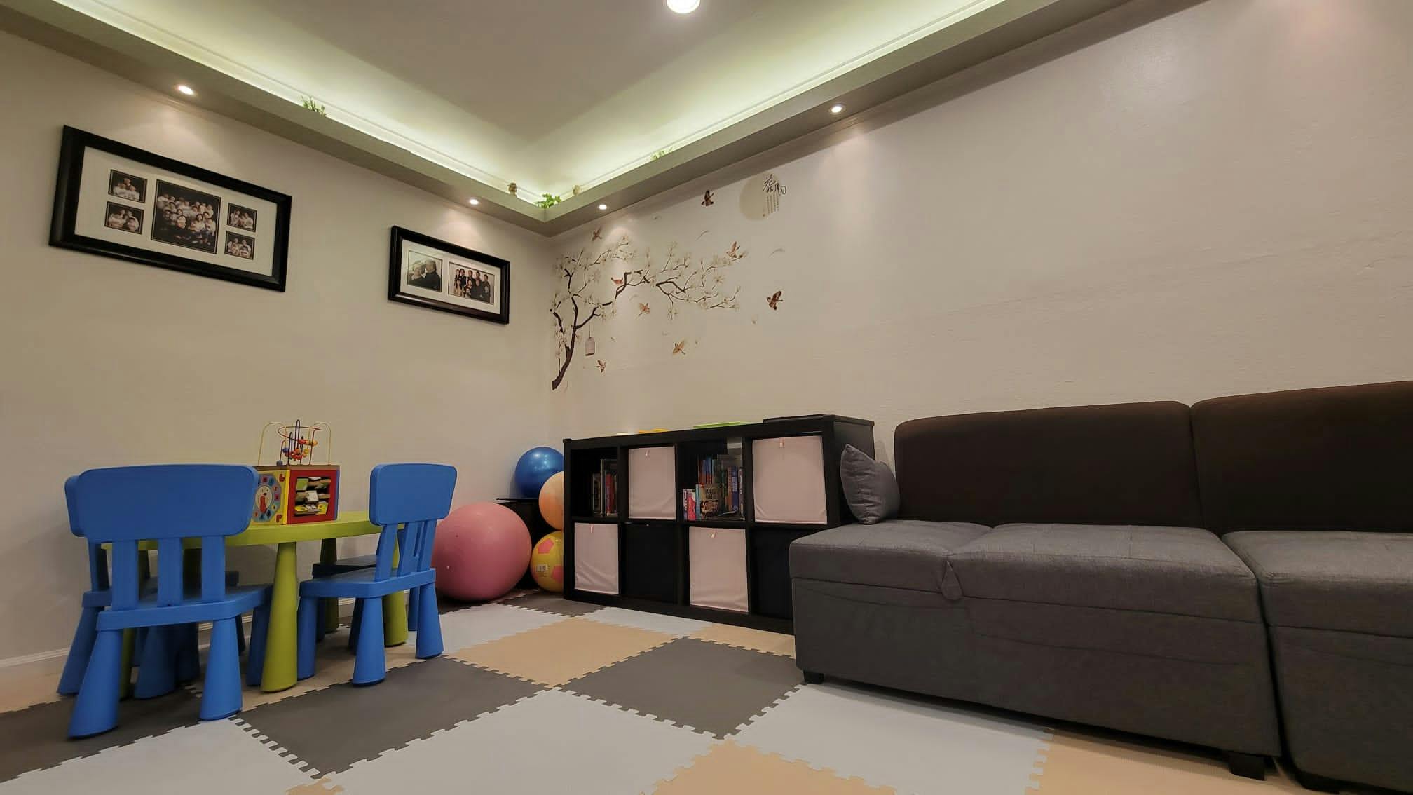 Playroom with small table and chairs, storage unit, and sofa
