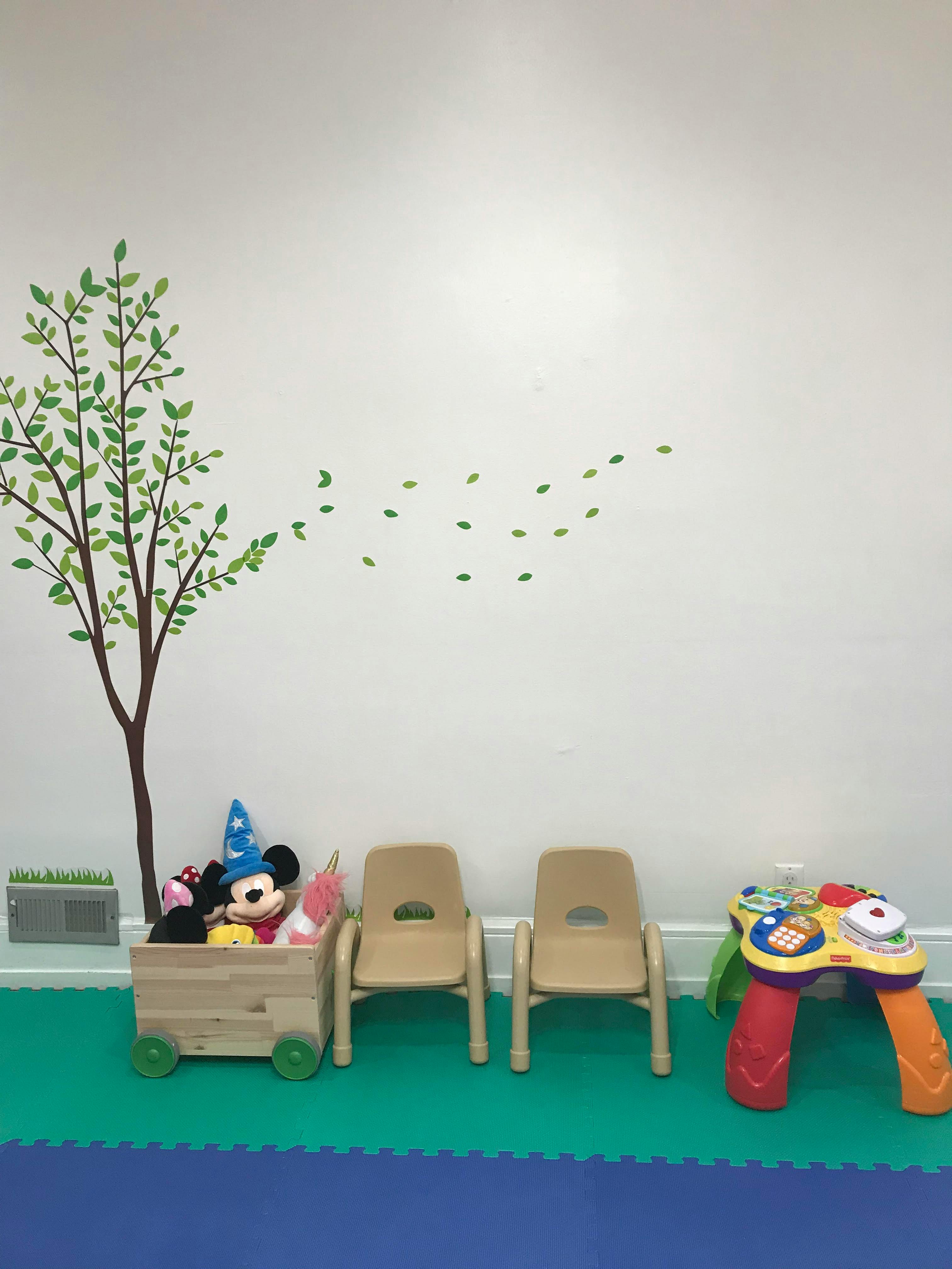 Playroom with small chairs, toy wagon, and activity table
