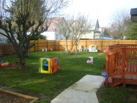Playground with colorful play structure and wooden deck