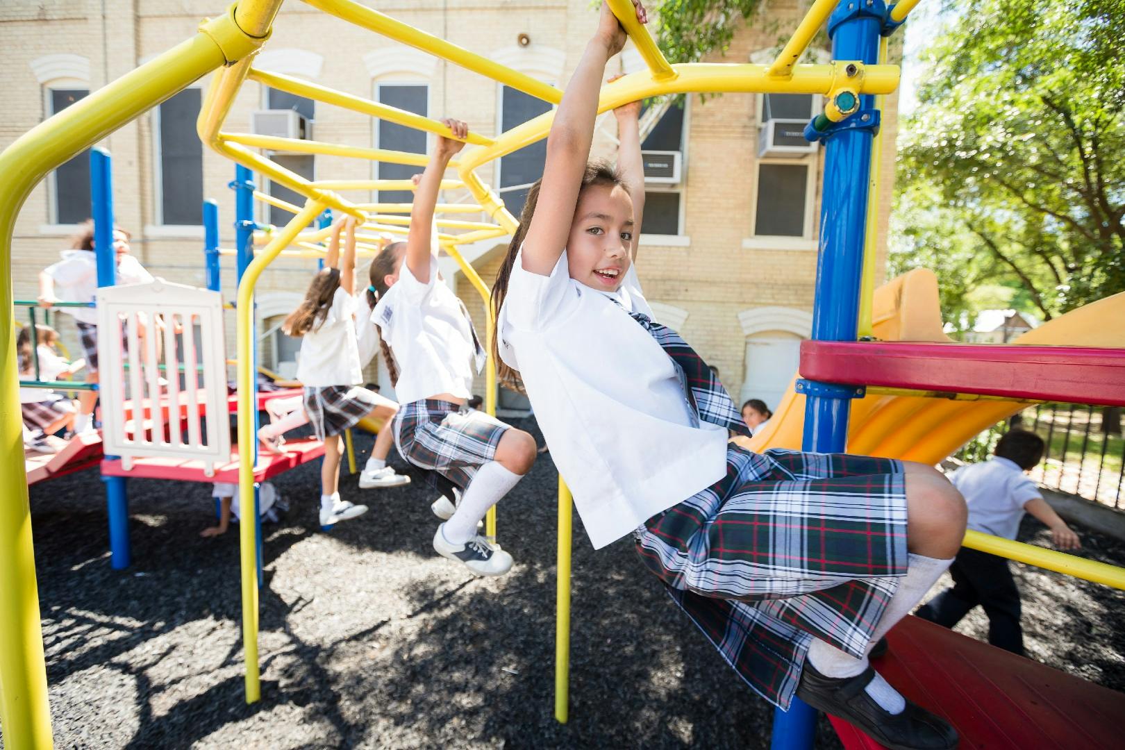 Children playing on monkey bars on a playground