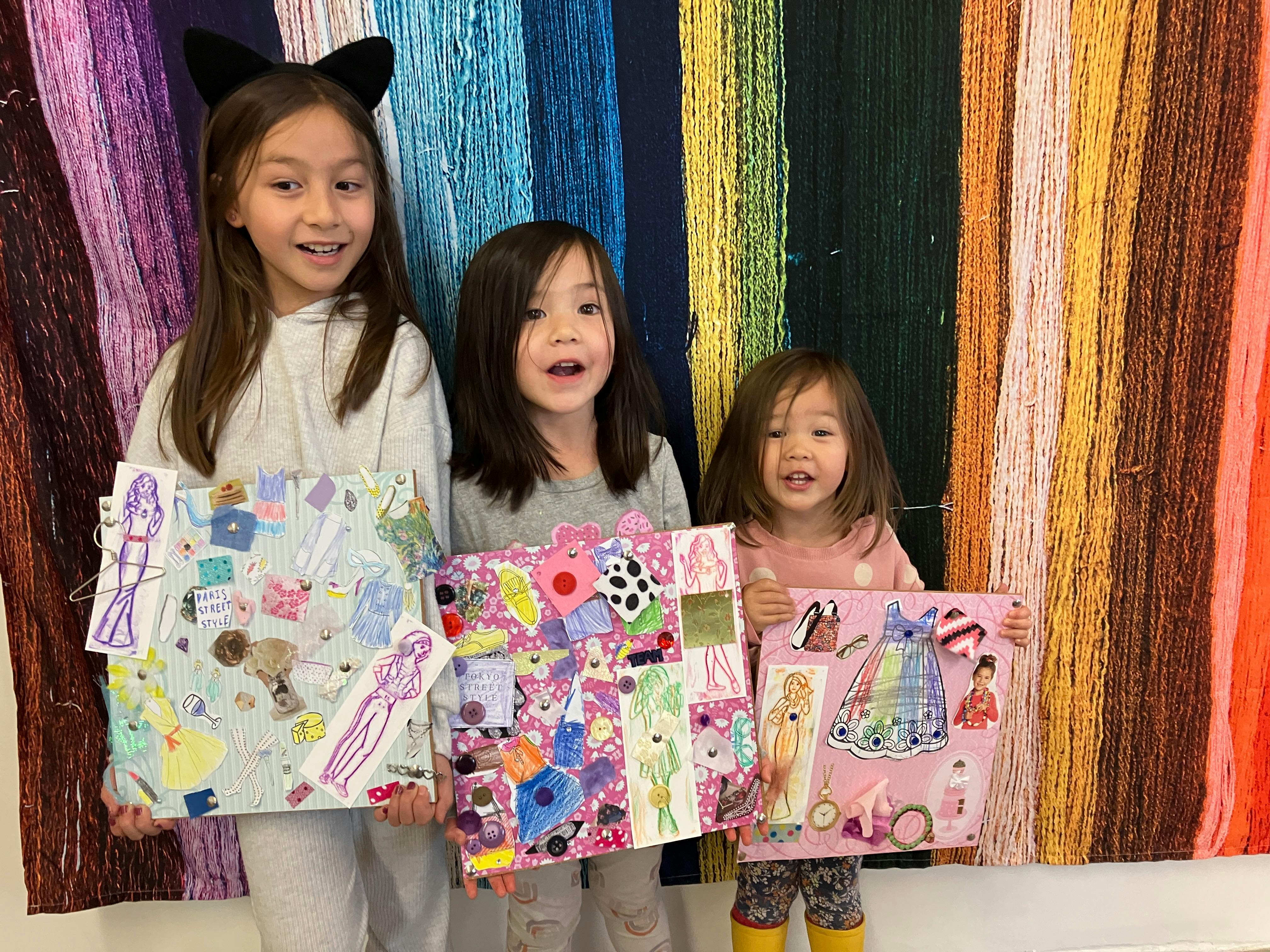 Three children holding up fashion collage boards