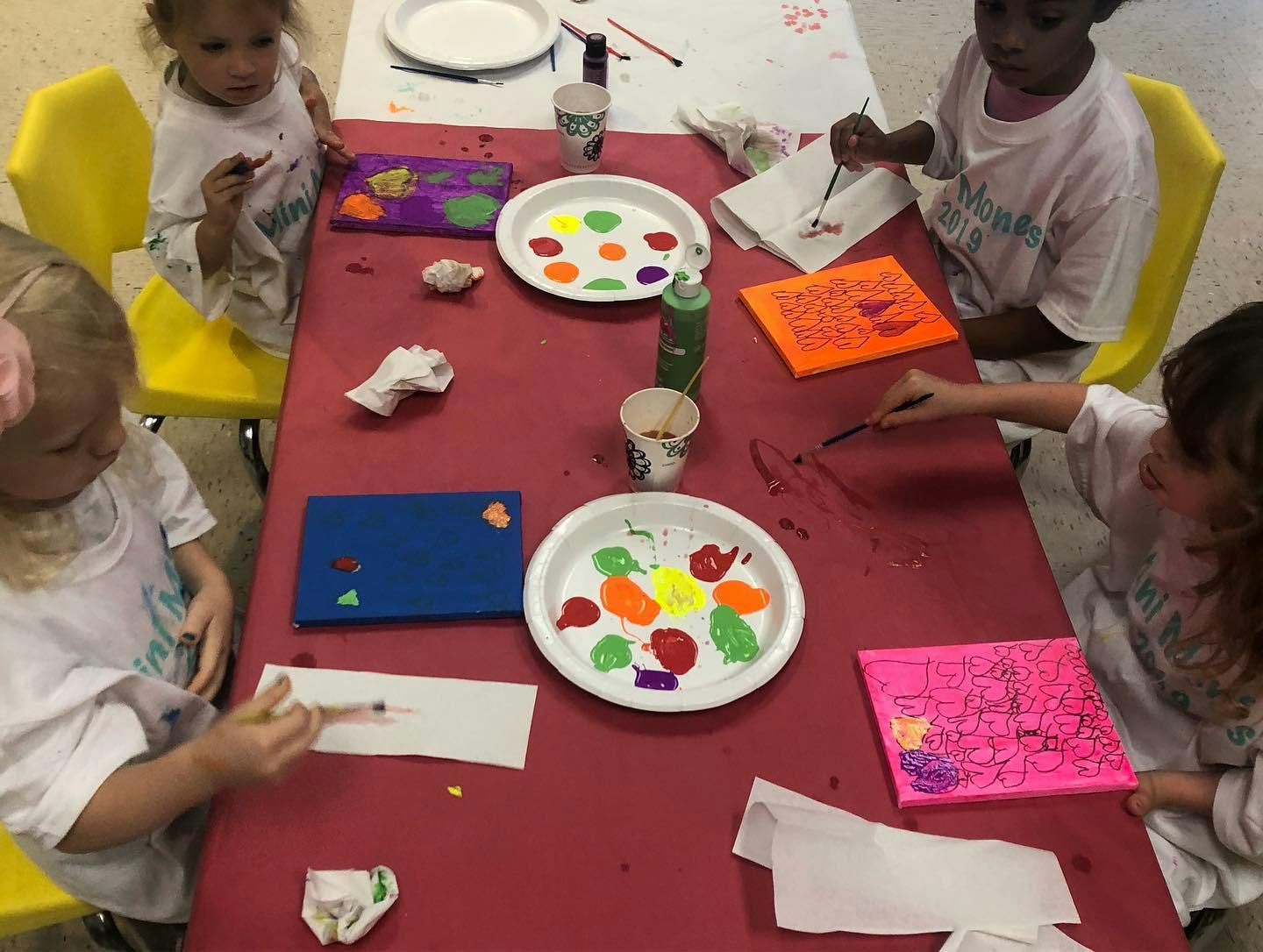 Children painting at a table