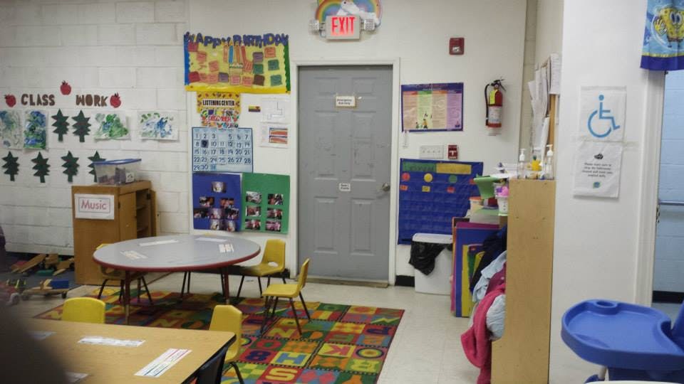 Classroom with small tables and chairs, decorated walls