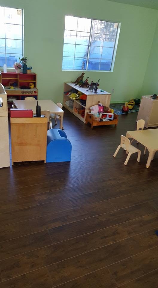 Playroom with small tables, chairs, and toys