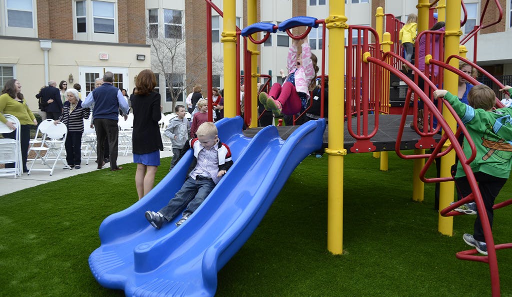 Child on a blue slide on a playground