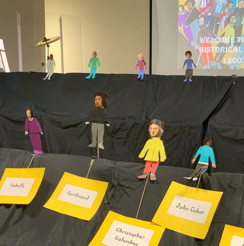 Cutout figures of people on display with name tags