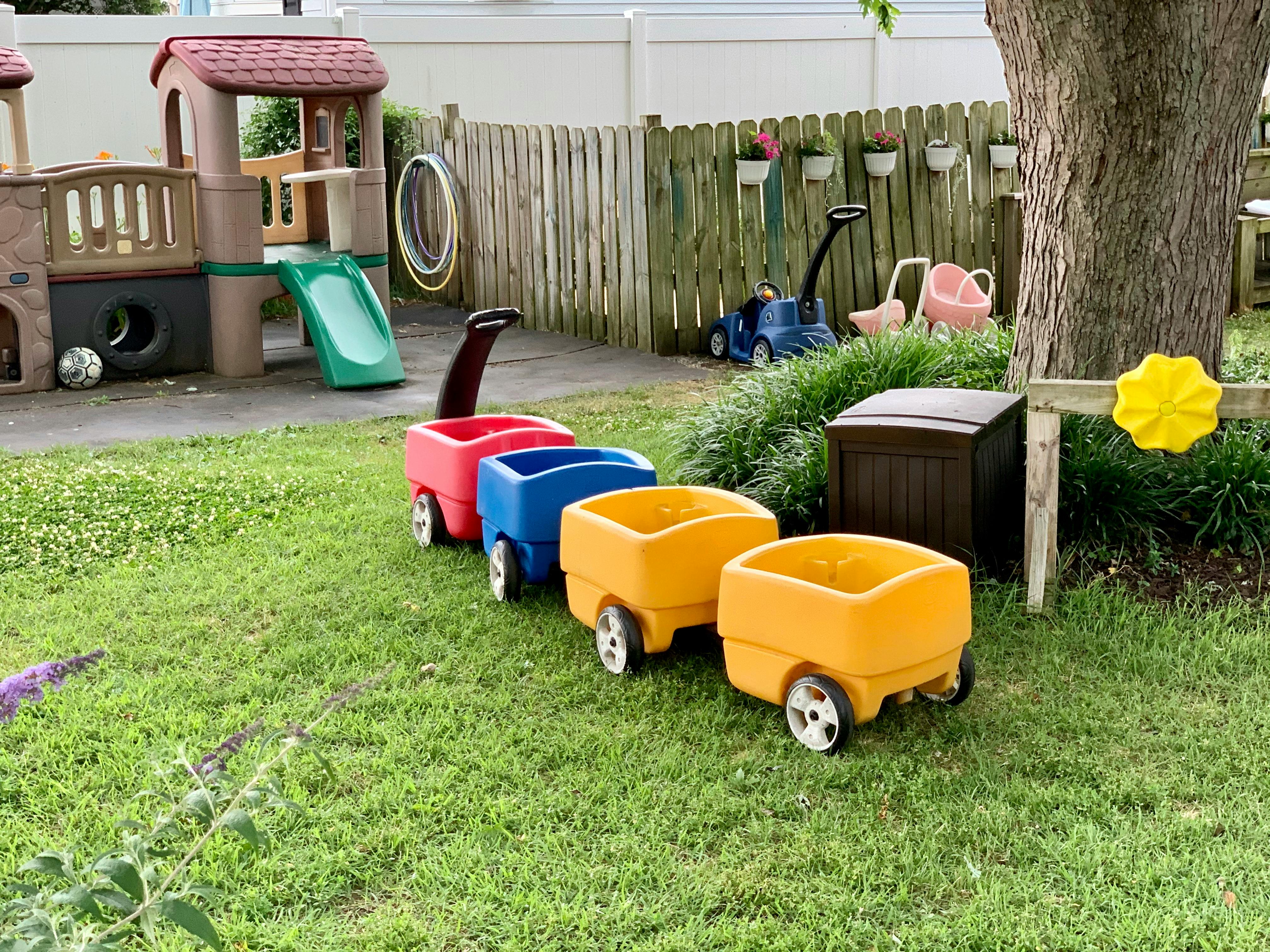 Toy wagons on grass in a playground
