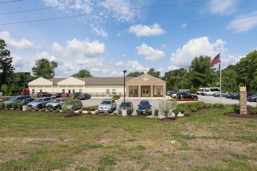 Building with a parking lot and an American flag
