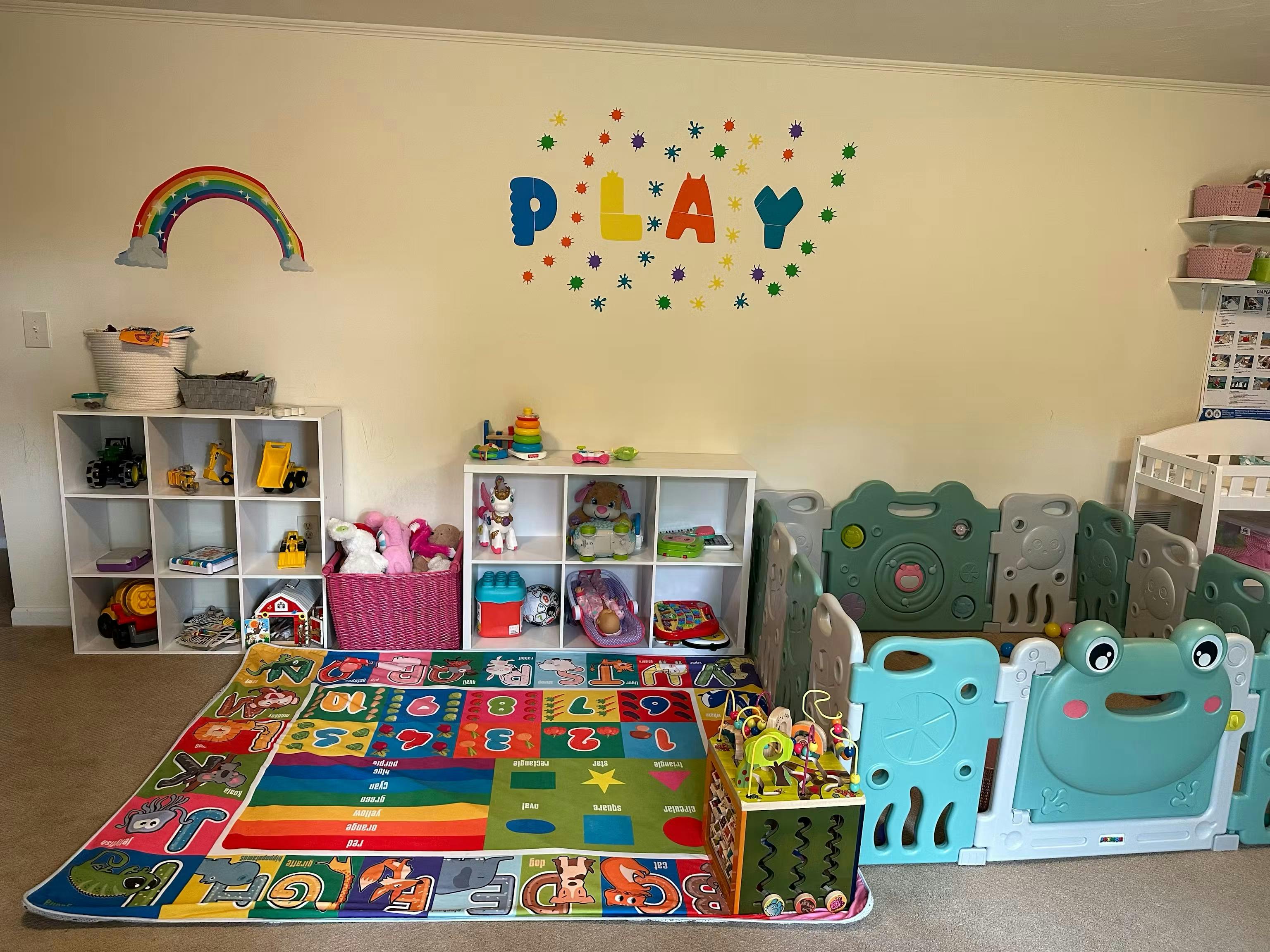 Playroom with organized shelves, toys, educational play mat, and playpen