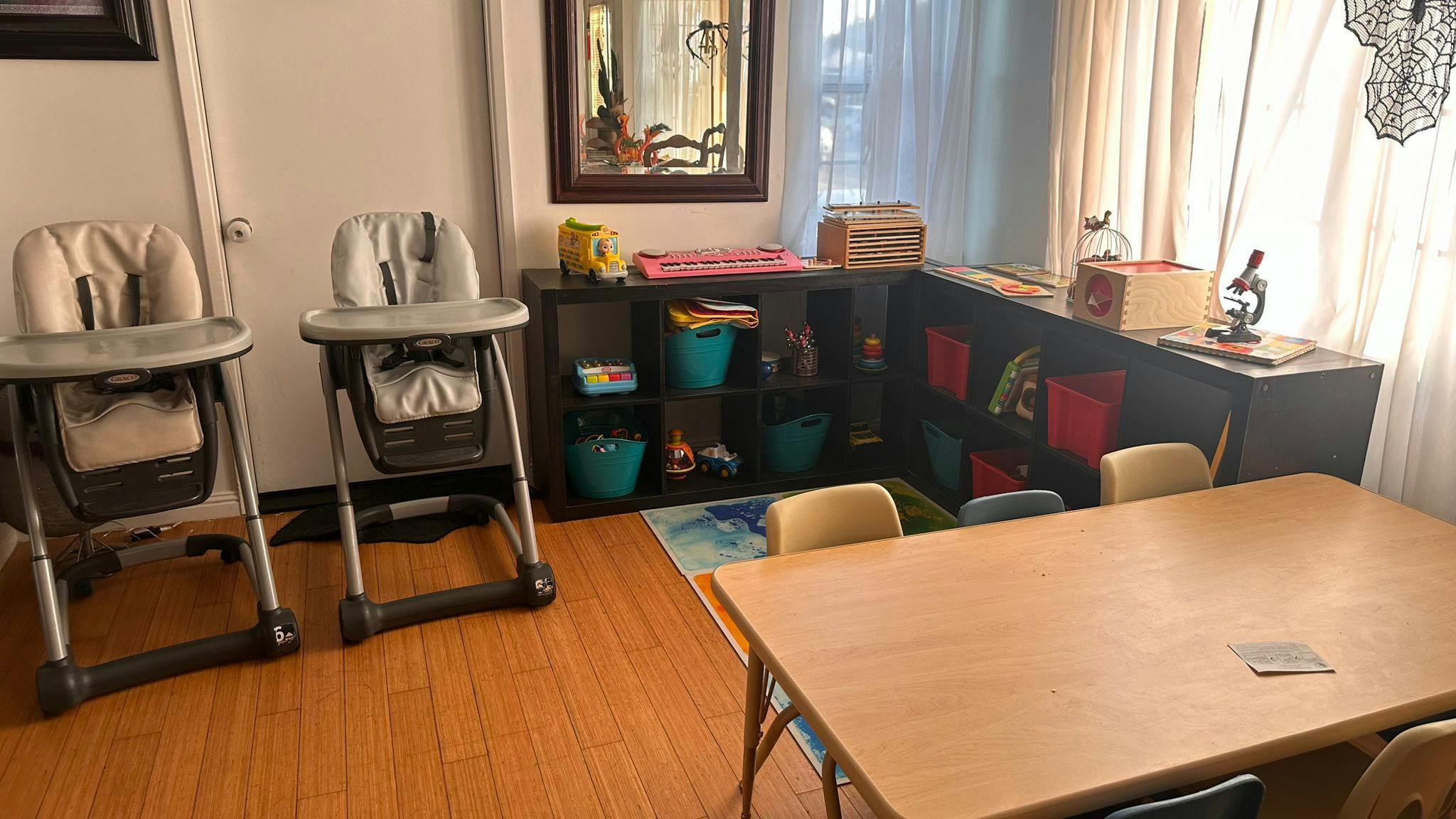 Two high chairs and a table with chairs in a room