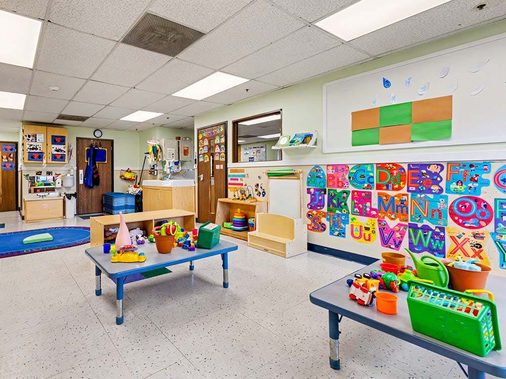 Colorful classroom with child-sized tables and toys