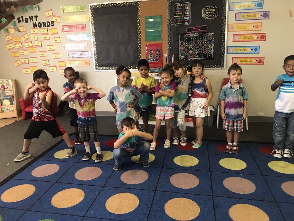 Children in a classroom making funny faces and poses