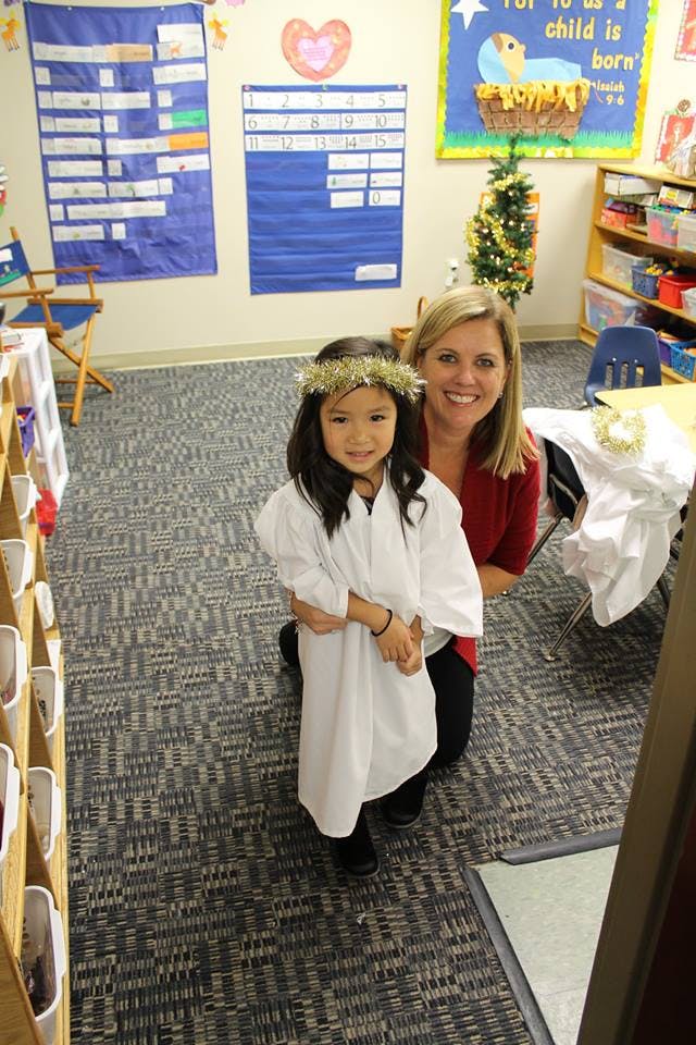 Adult and child in a classroom