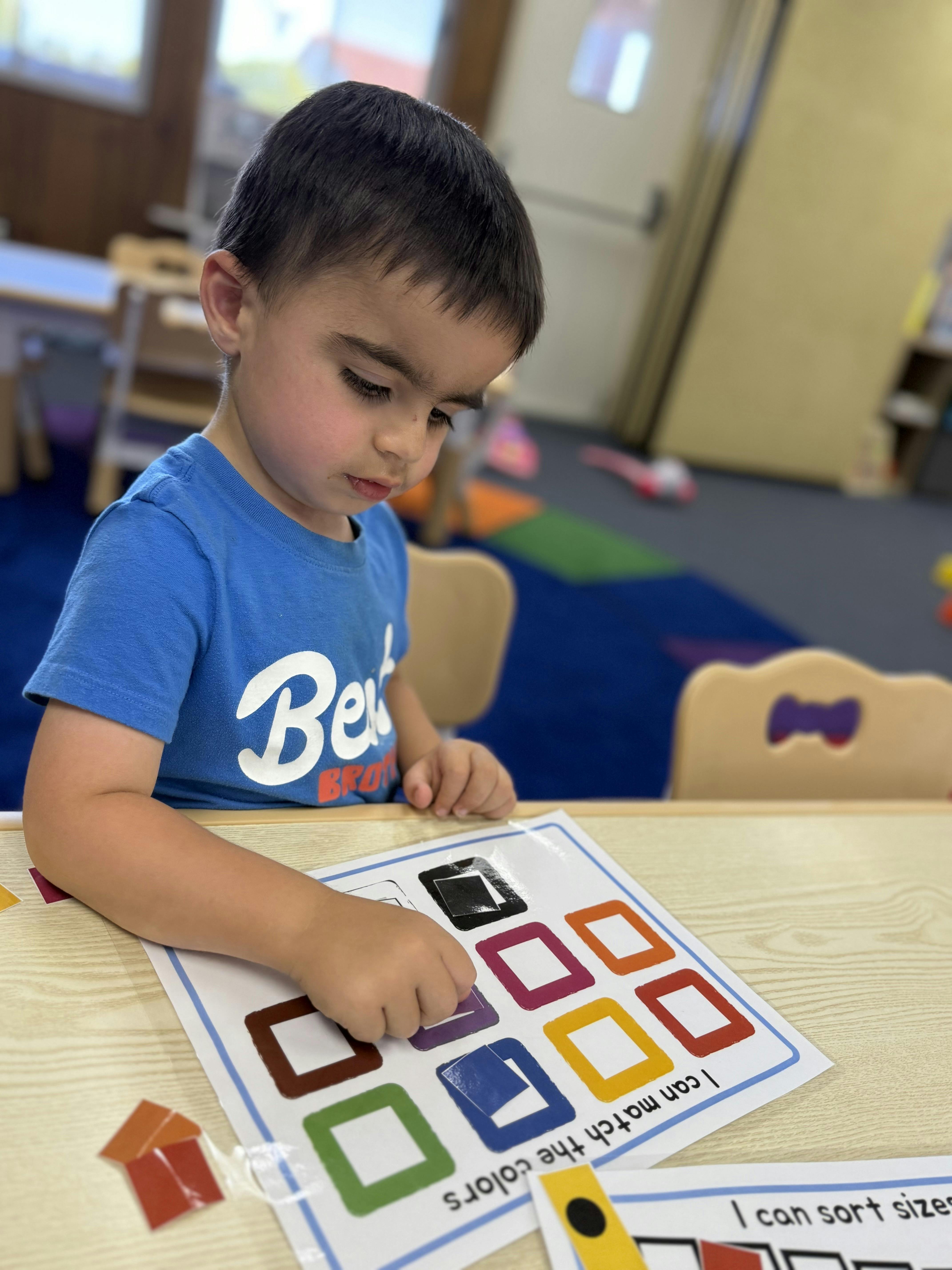 Child matching colors on a learning activity sheet