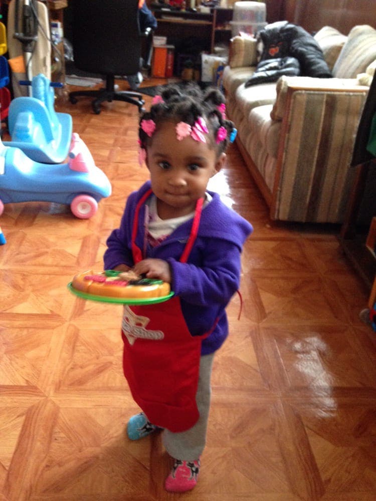 Child holding a toy pizza