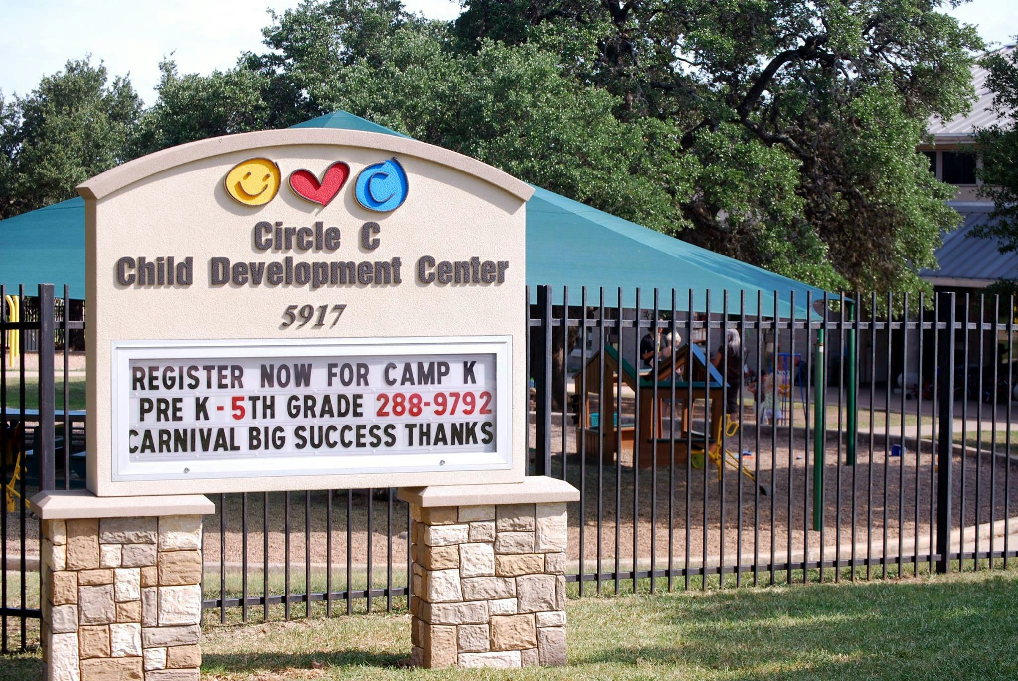 Sign for Circle C Child Development Center with text about Camp K