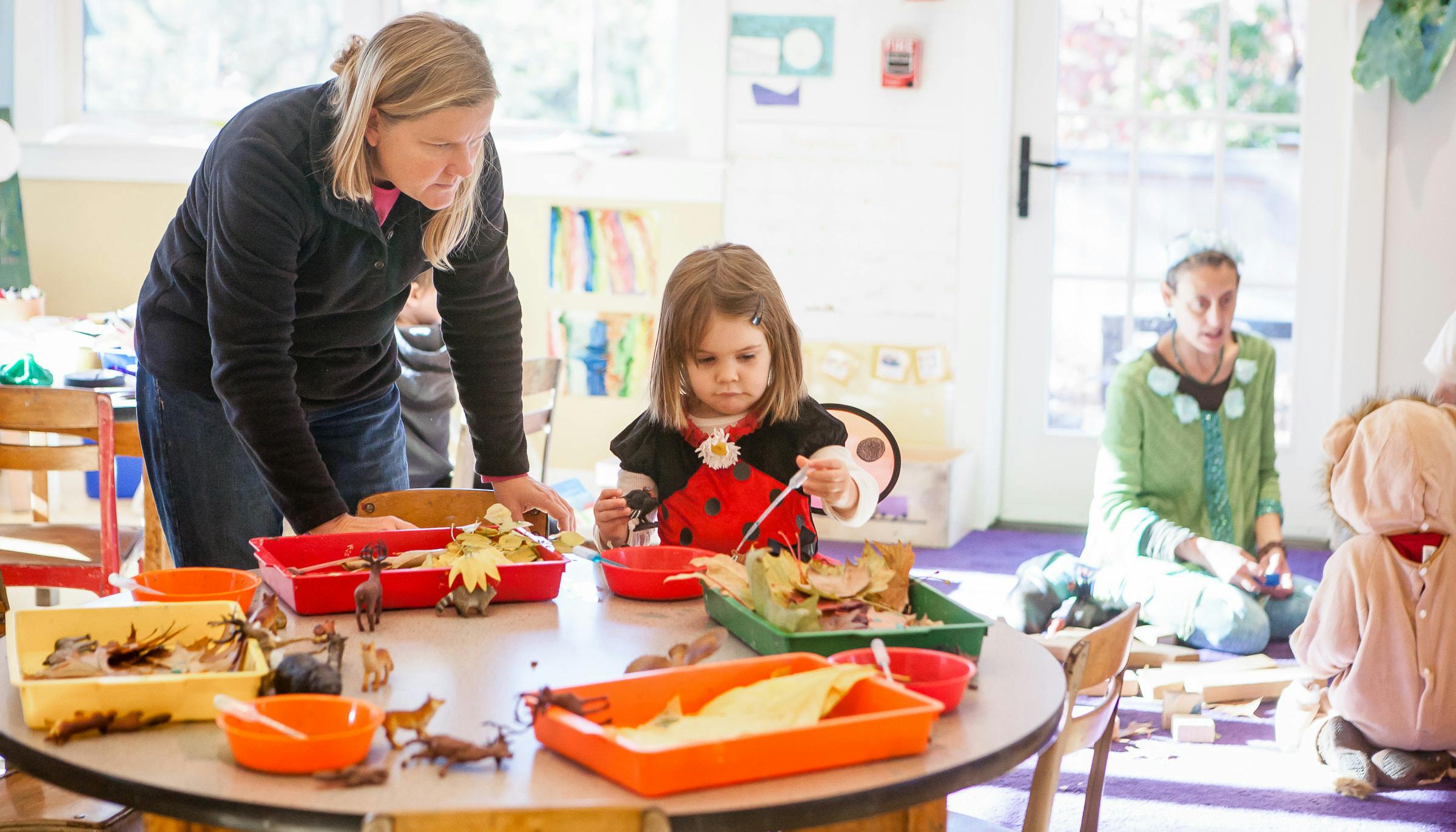 Adult and child at a table with craft supplies