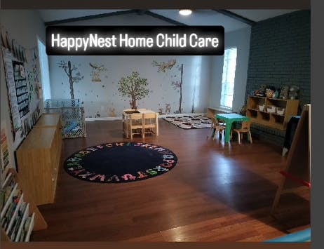 Child care room with small tables, chairs, and a round rug