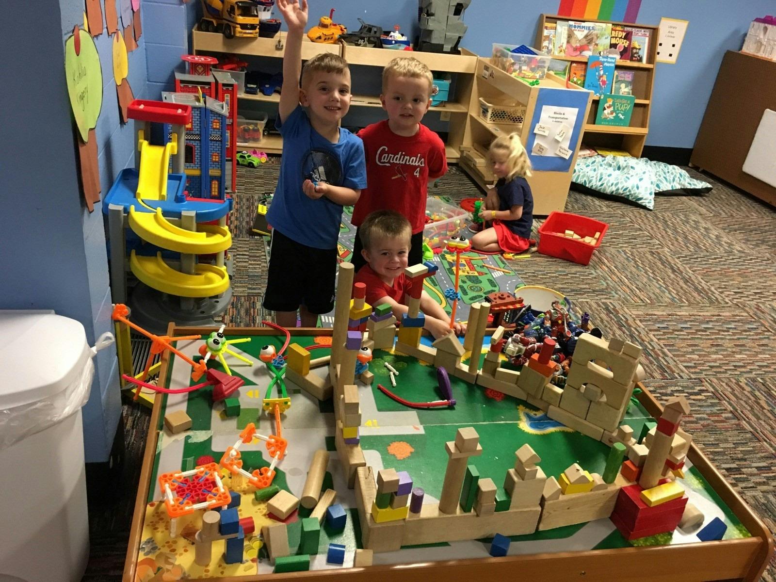 Children playing with blocks and toys in a classroom