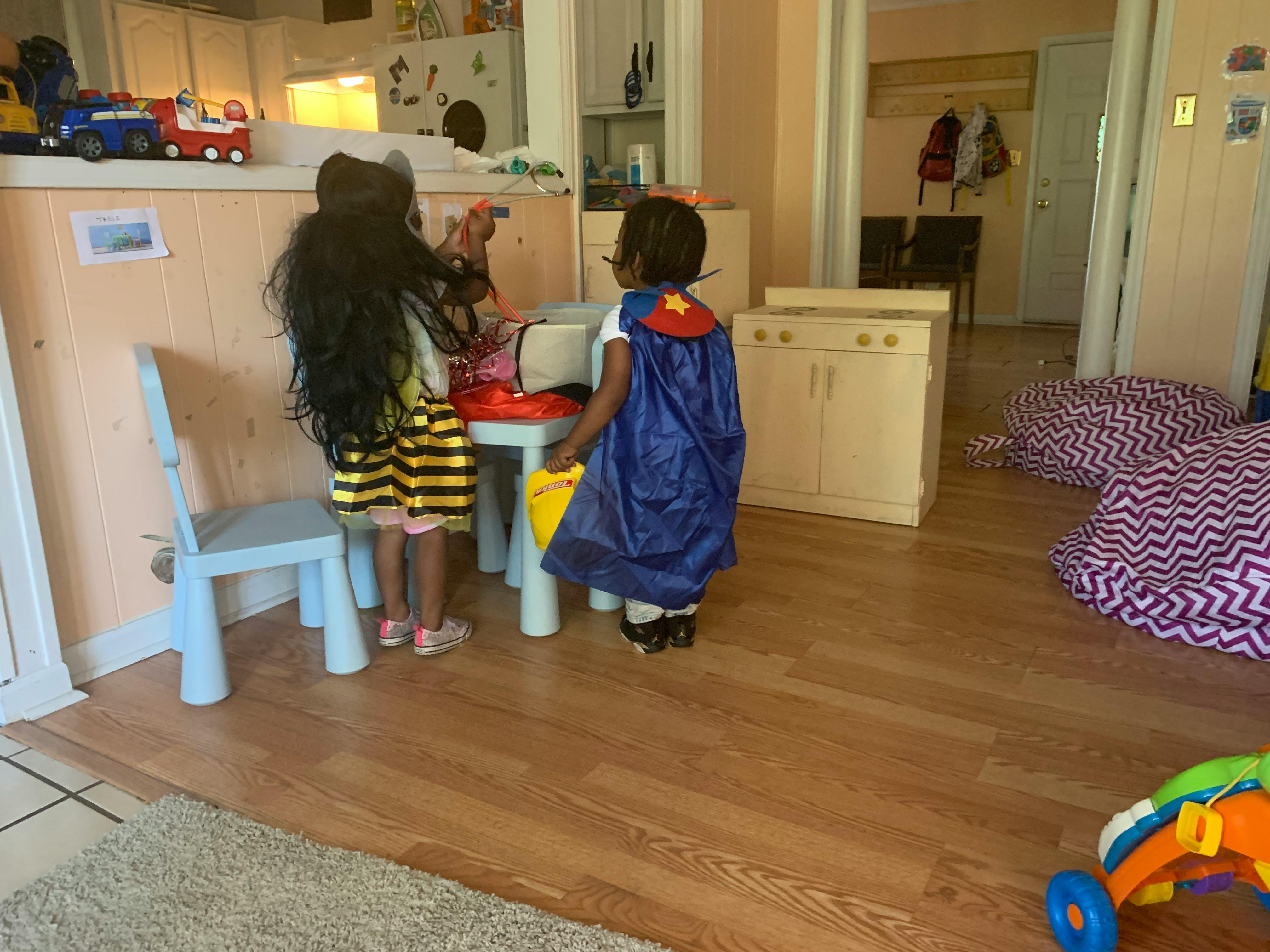 Two children playing at a small table