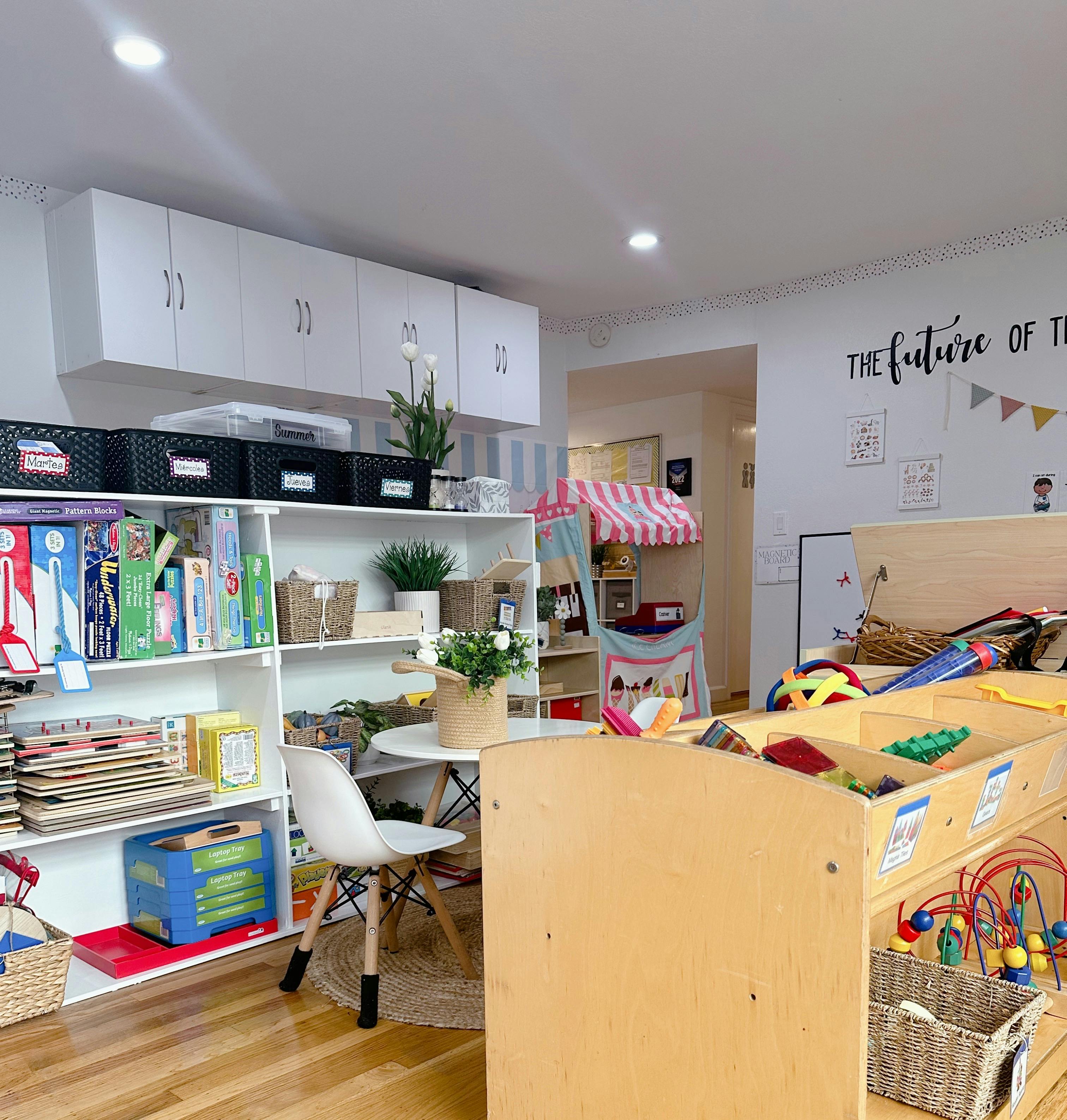 Classroom with shelves of books and toys, small table and chairs