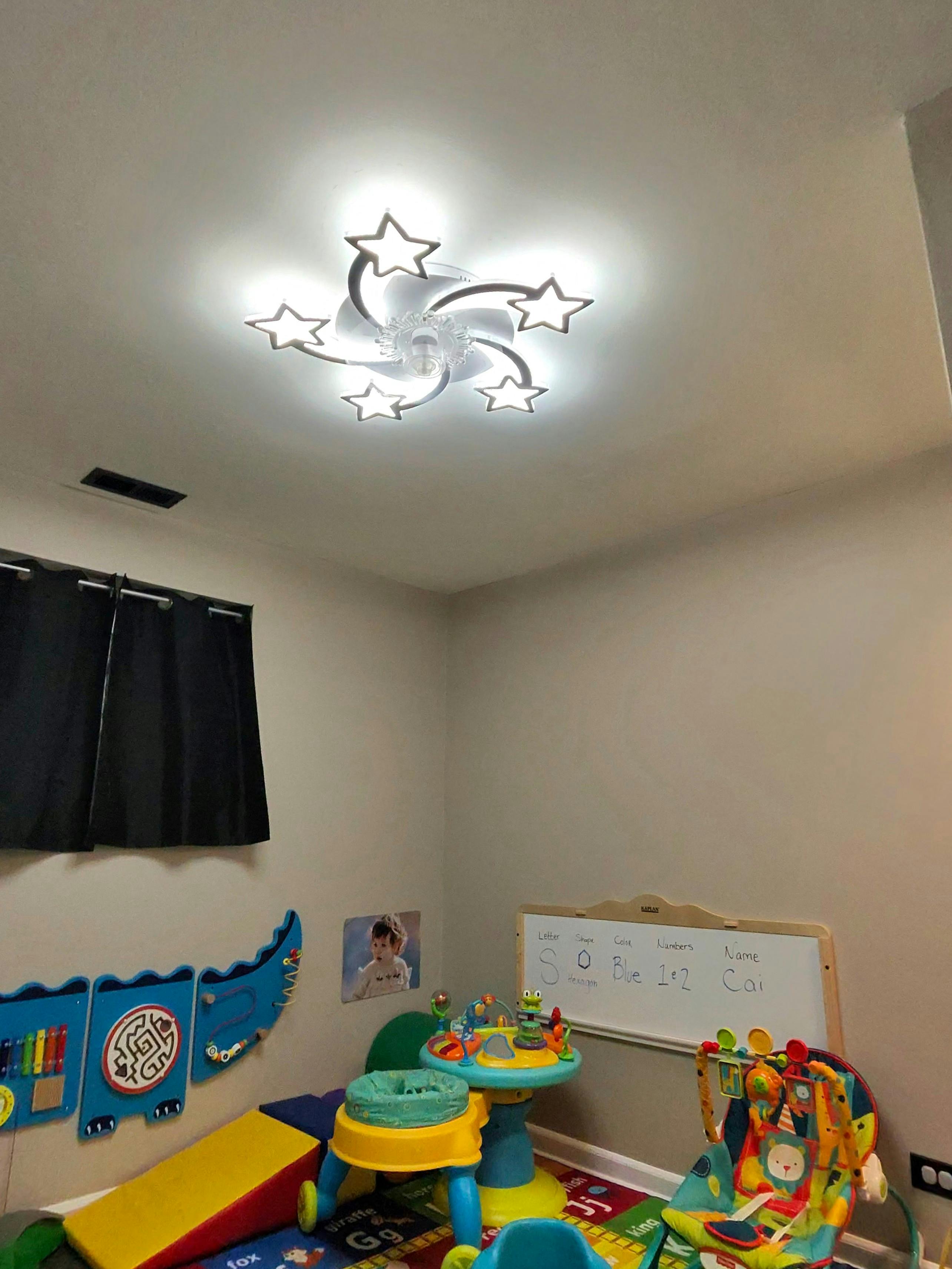 Playroom with a star-shaped ceiling light fixture and educational toys