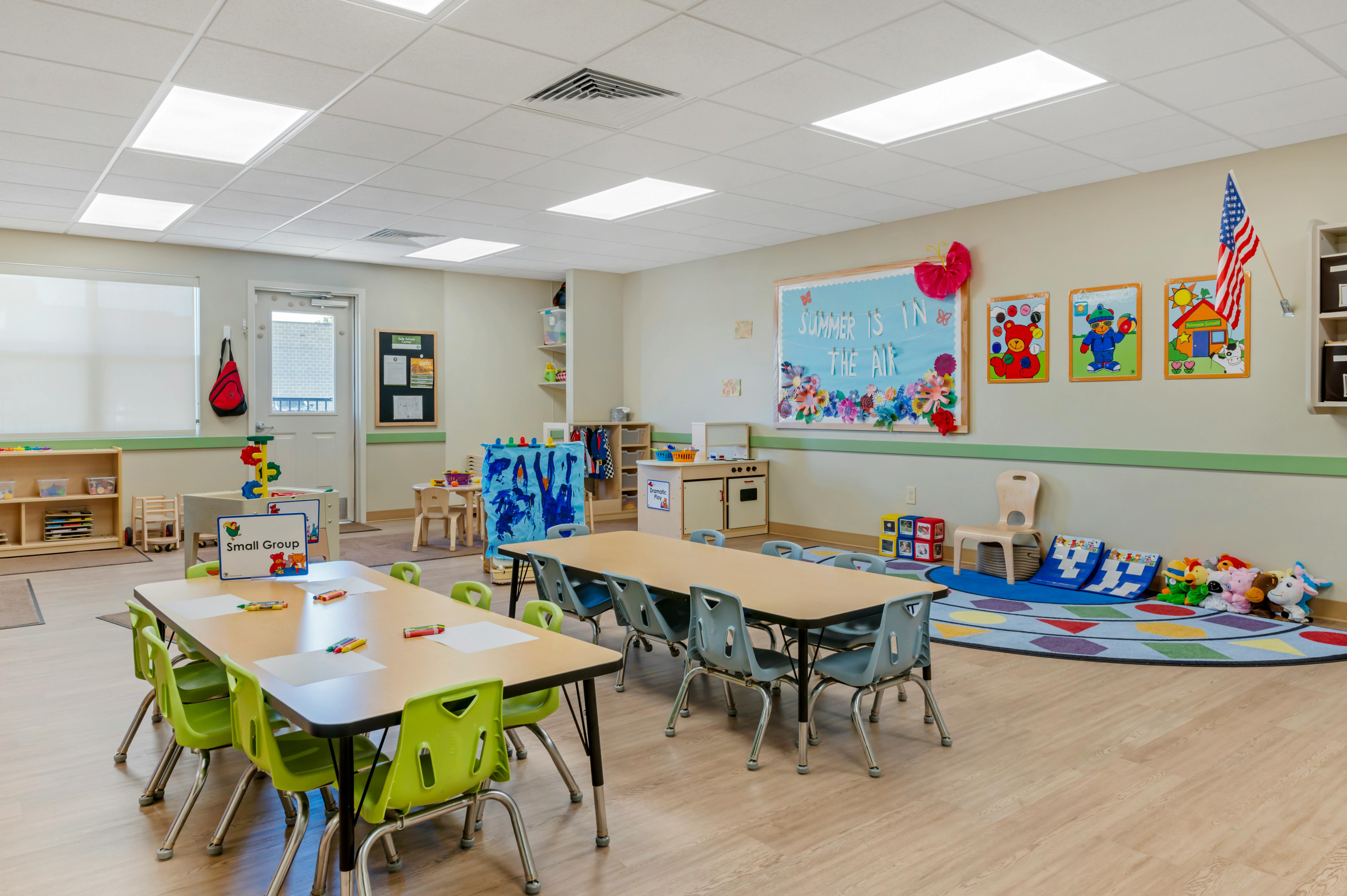 Classroom with tables, chairs, and play areas