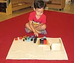 Child playing with blocks on a mat