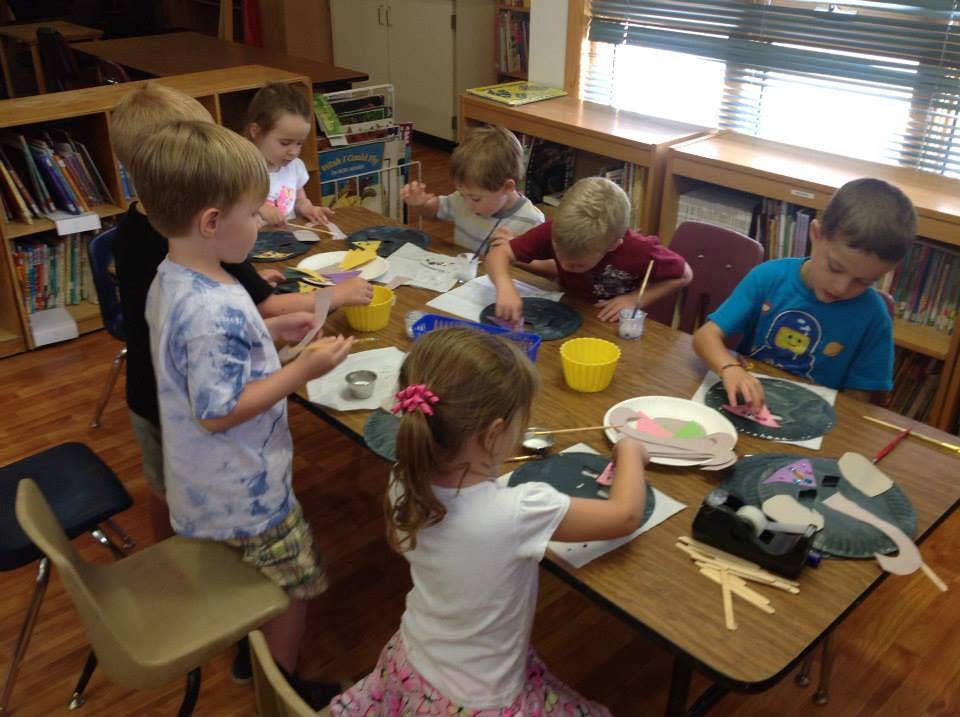 Children doing crafts at a table