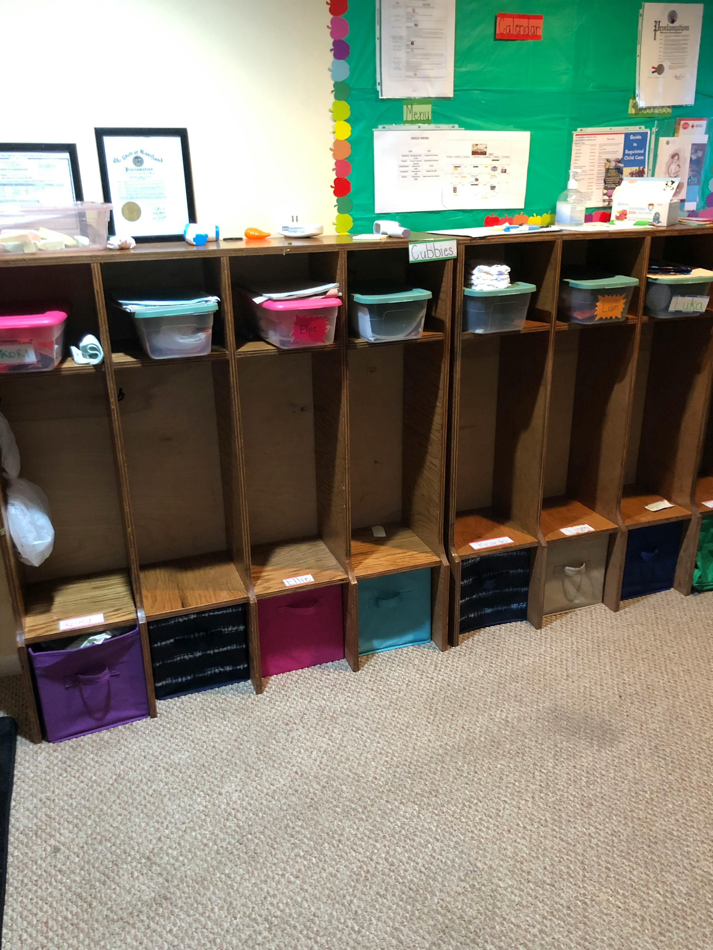 Wooden cubbies with colorful bins and containers in a classroom